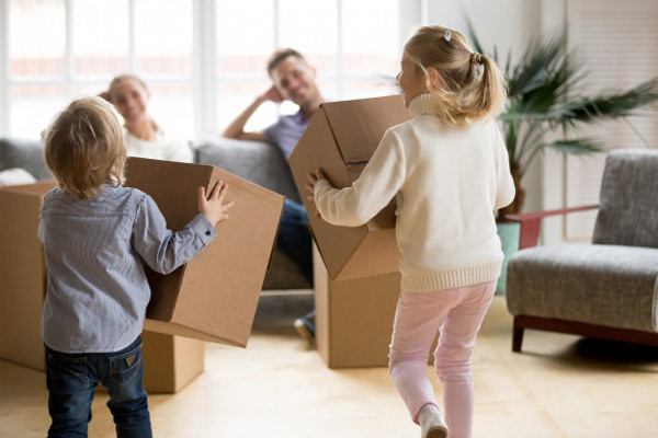 Família segurando caixas para mudança para um novo apartamento